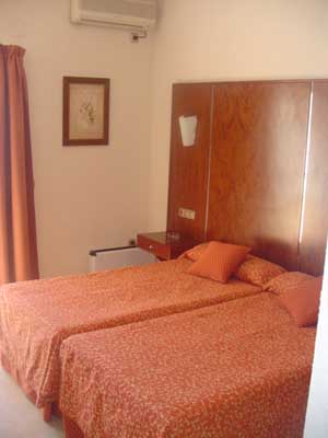 Standard triple with city view, and private facilities (bath and shower)